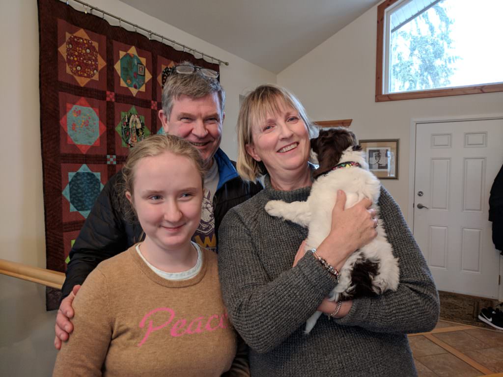 Mother, Father and Daughter with their new labradoodle puppy